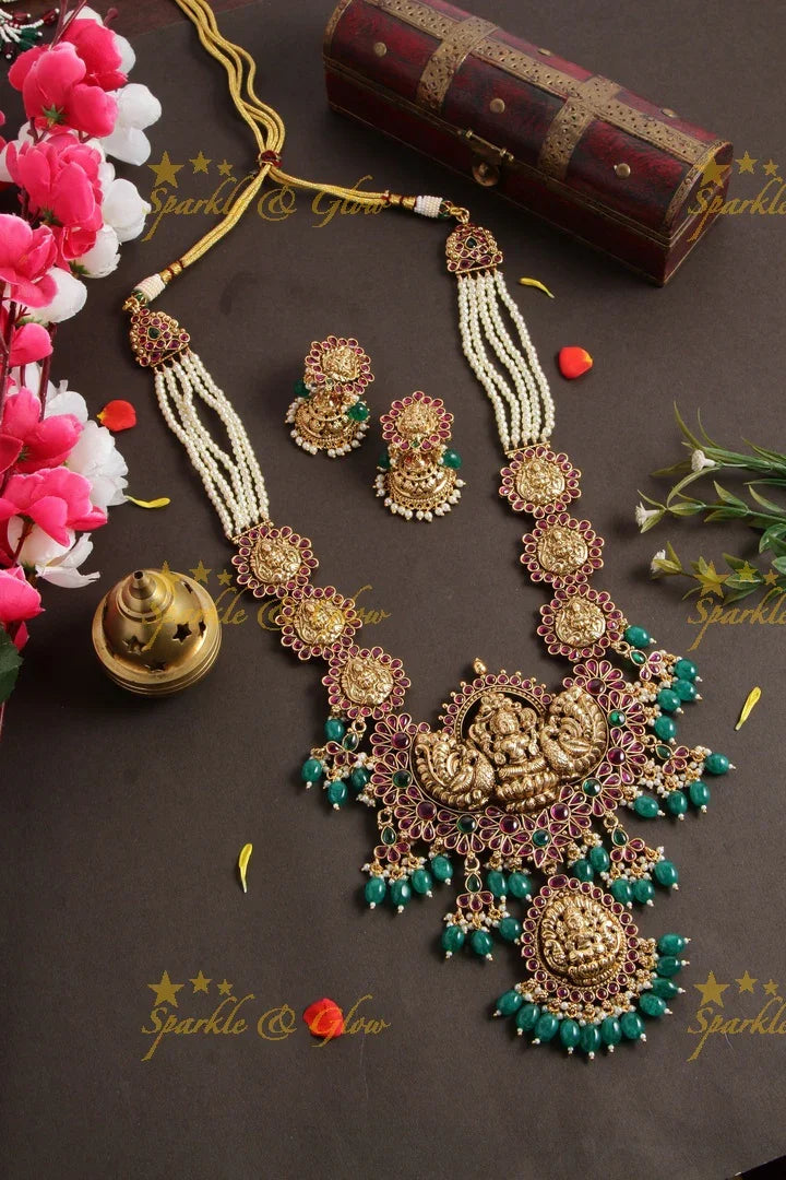 Grand Lakshmi peacock long necklace with multi layer pearl chain red colour stones and green beads - Sparkle and Glow